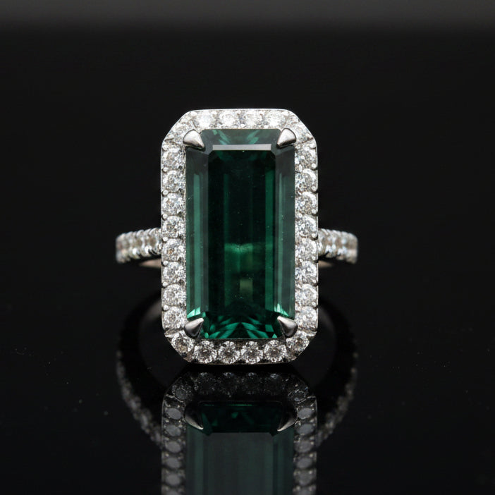Estate jewelry — An Indicolite Tourmaline Ring, Emerald Cut, in White Gold, 12.60ct emerald-cut indicolite tourmaline with diamond halo