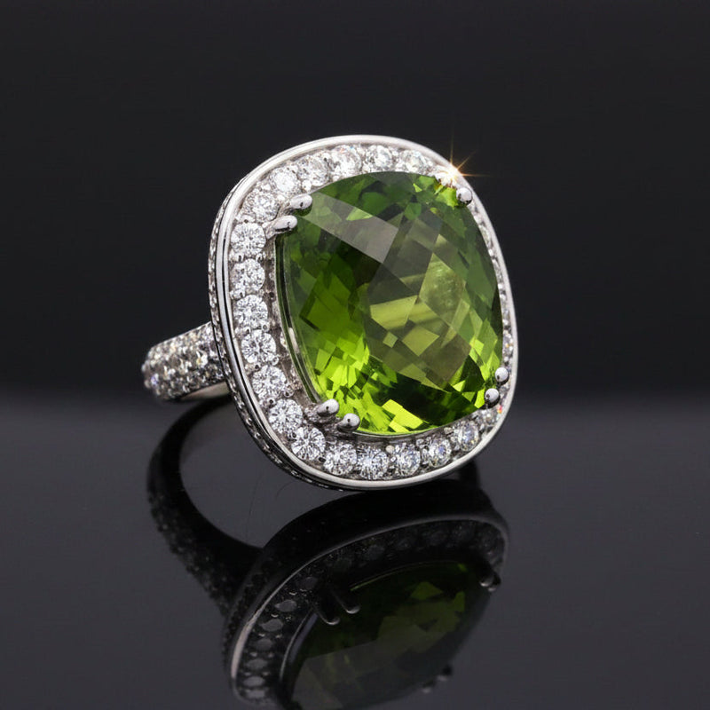 Estate jewelry — A Peridot Ring, Cushion Cut, in White Gold, 27.73ct cushion-cut peridot with diamond halo in 14K white gold
