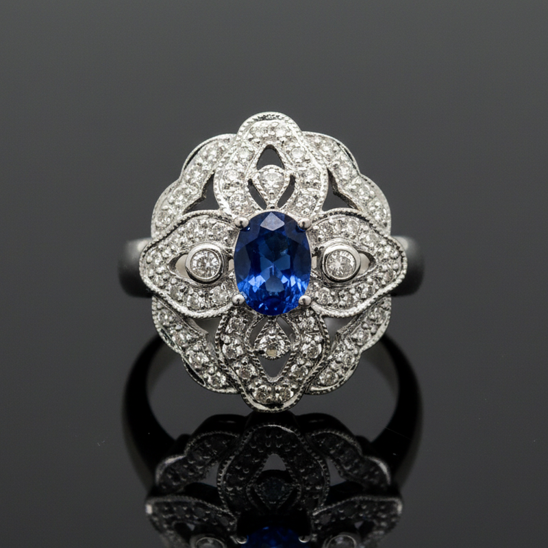 Estate jewelry — A Sapphire and Diamond Ring, in White Gold, sapphire and diamond halo in 14K white gold