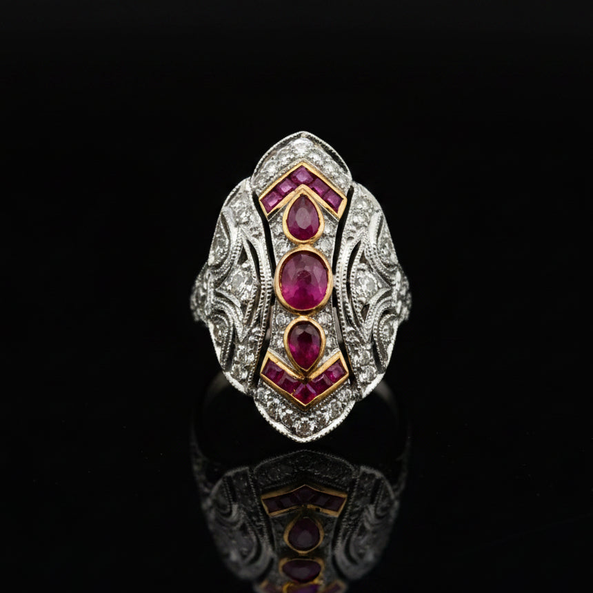 Estate jewelry — A Shield of Rubies, in Two-Tone Gold, Ruby, cabochon/pear cut, 0.70 cttw, VS2-SI1 clarity